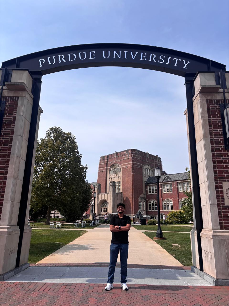 Himanshu Laddhad standing under the Purdue University arch